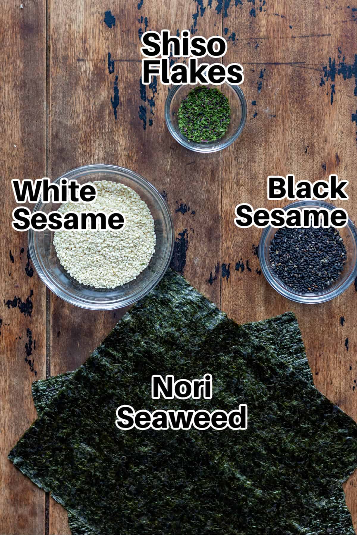 Labelled ingredients on a table: sesame seeds, nori, shiso flakes.