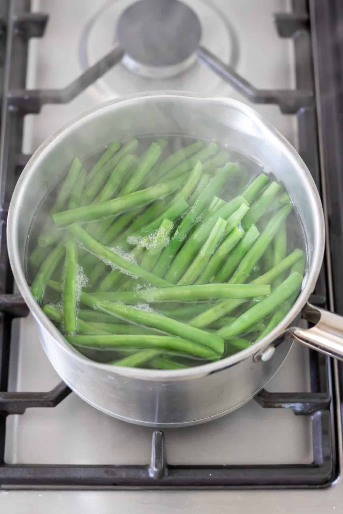Simmering green beans on the stovetop.